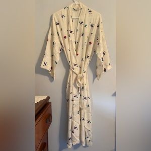 100% silk robe. floral design on cream background. comes with silk storage bag.